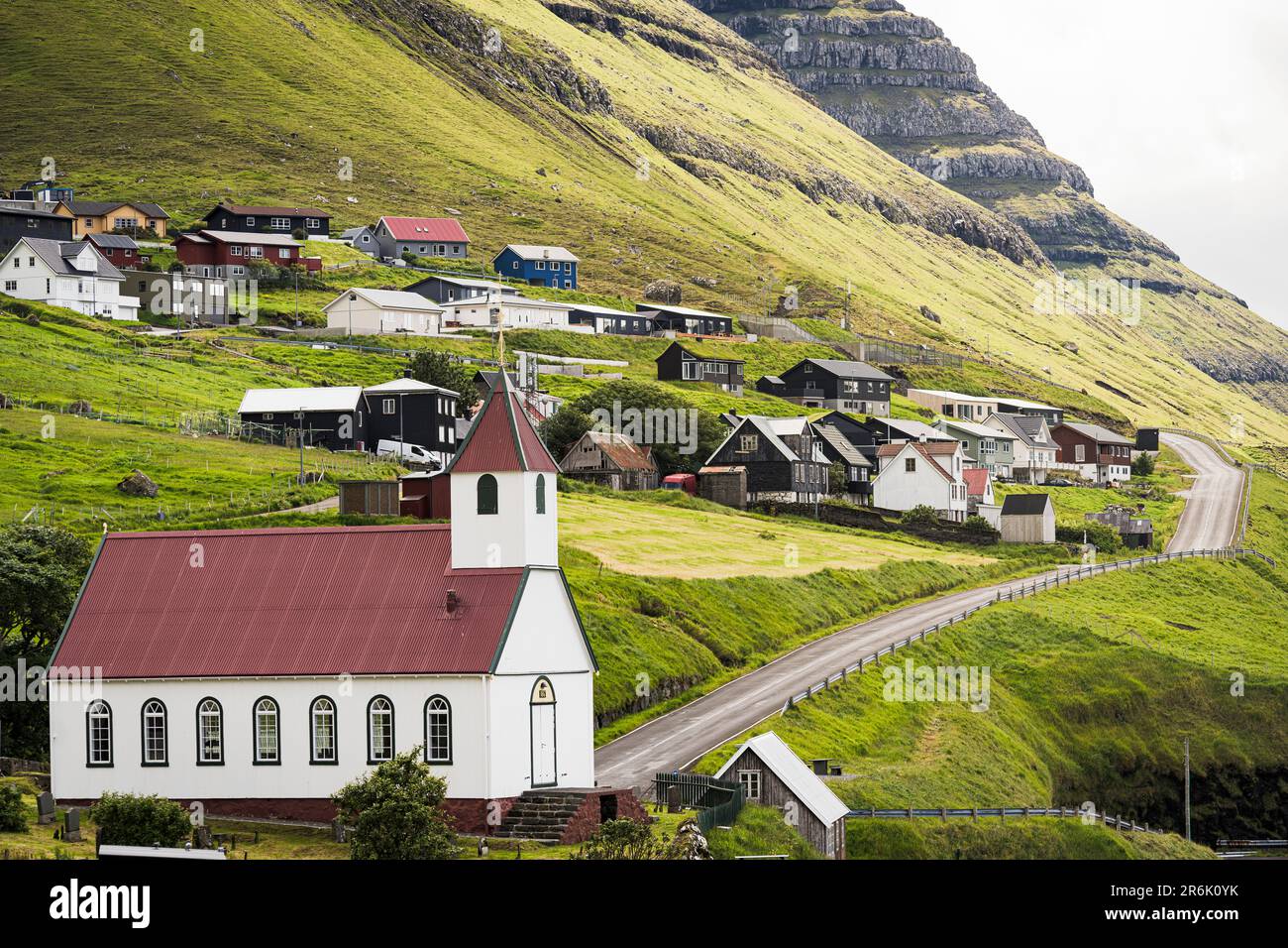 Traditional houses and church in the coastal village of Kunoy in summer, Kunoy Island, Faroe Islands, Denmark, Europe Stock Photo