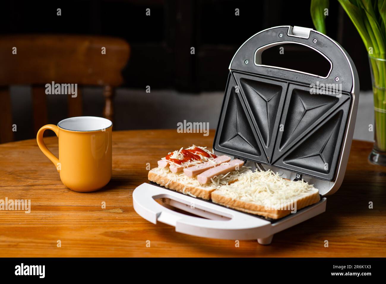 https://c8.alamy.com/comp/2R6K1X3/open-sandwich-maker-with-cheese-toast-and-sausages-sandwiching-2R6K1X3.jpg