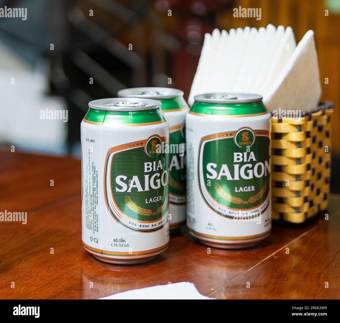 Three cans of Bia Saigon, Saigon Beer, at a restaurant in Vietnam. Bia Saigon is one of the most popular beers in Vietnam, produced by Vietnam's large Stock Photo