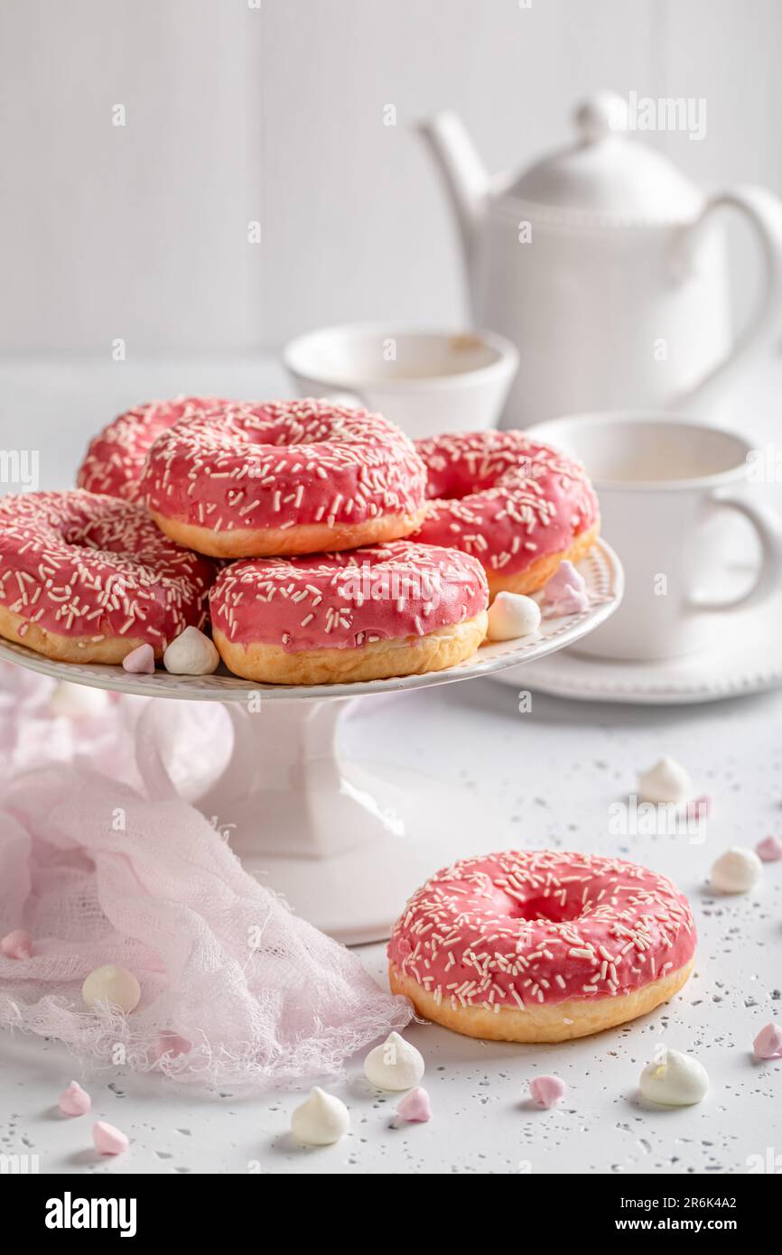 Sweet and homemade pink donuts and coffee ready to eat. Donuts and
