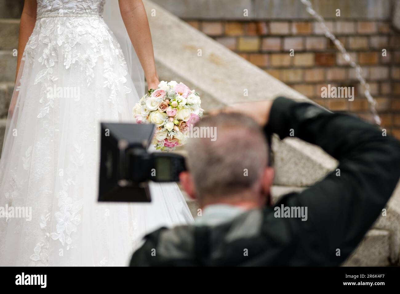 Photographer taking picture of bride Stock Photo