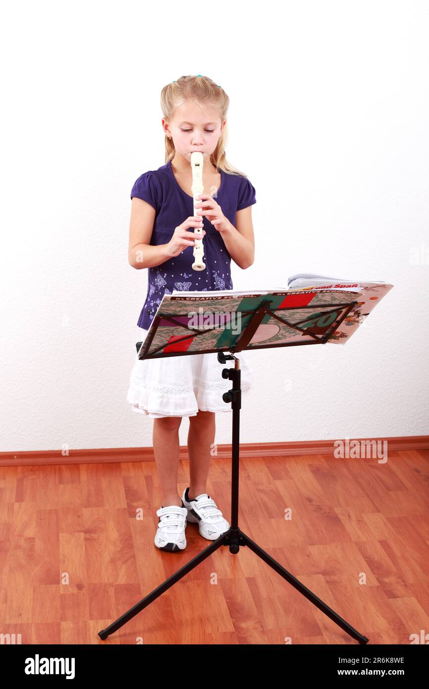 Cute girl playing flute with music notes Stock Photo Alamy