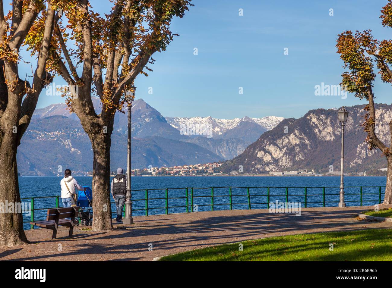 LECCO, ITALY/EUROPE - OCTOBER 29 : People walking along the promenade at  Lecco by Lake Como in Italy on October 29, 2010. Two unidentified people  Stock Photo - Alamy, image size:1300x956