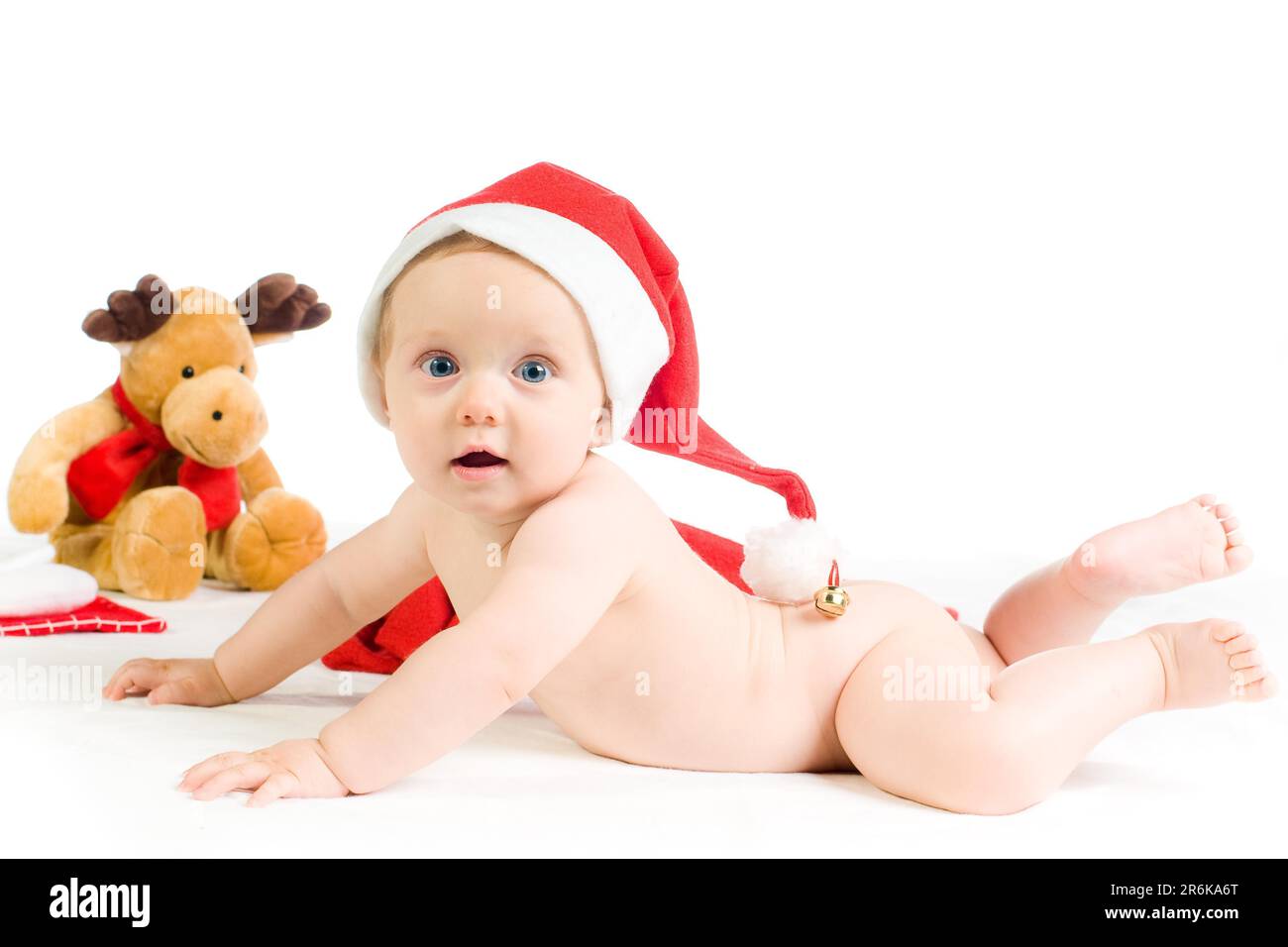 Cute baby with christmas hat and moose on white background Stock Photo