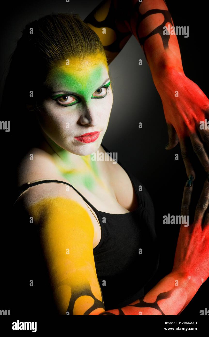 Red yellow green colourful painted woman as lowkey Stock Photo Alamy