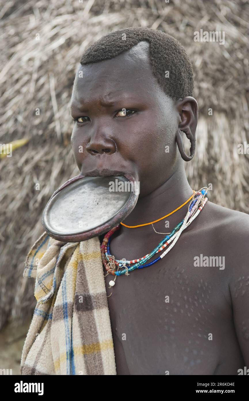 Surma woman with round lip plate, lip plate, Kibish, Omo Valley ...