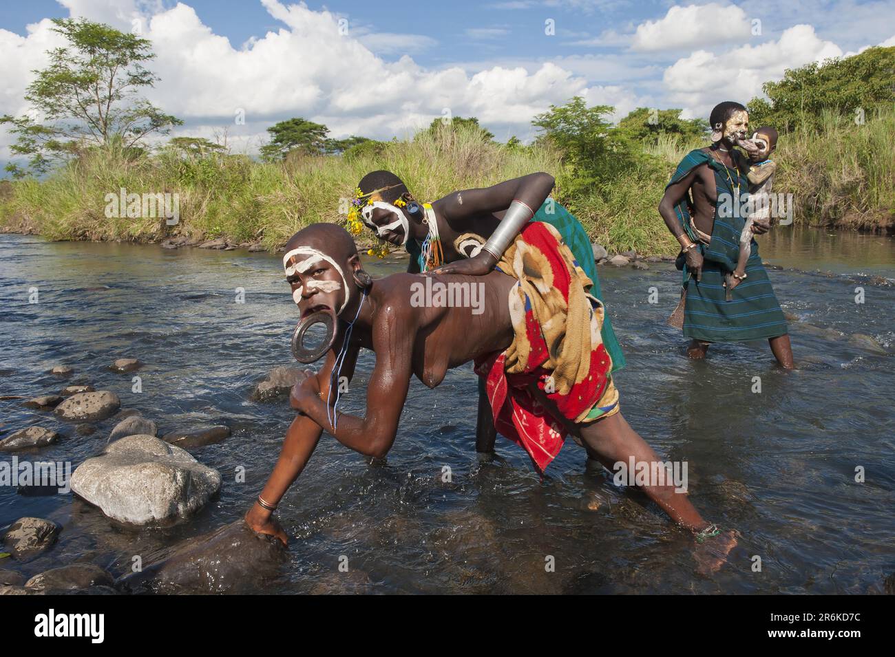 Surma woman with lip plate, lip plate, in the river, Kibish, Omo Valley, Ethiopia Stock Photo