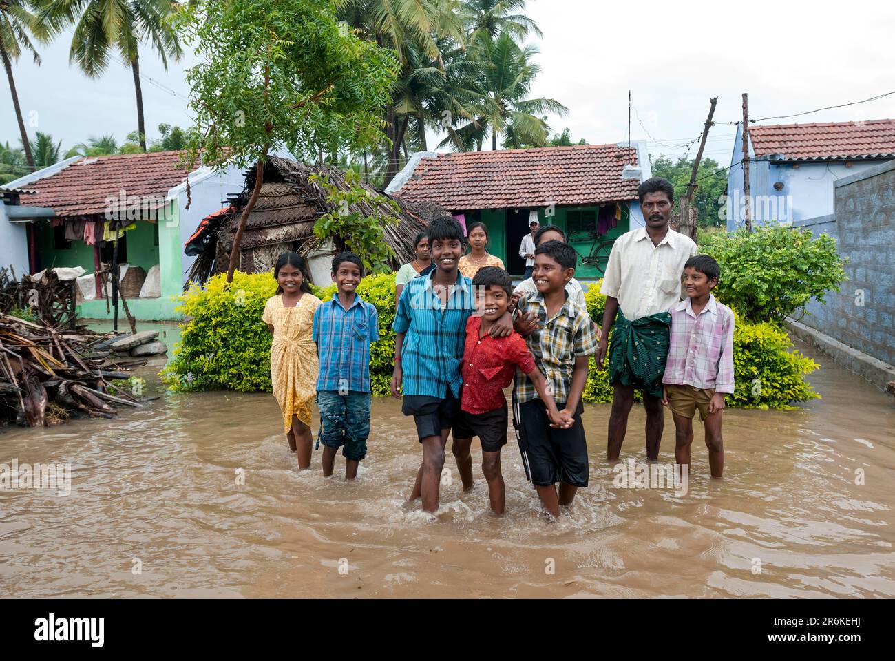 People standing outside their home flooded with rain water, Tamil Nadu, South India, India, Asia Stock Photo