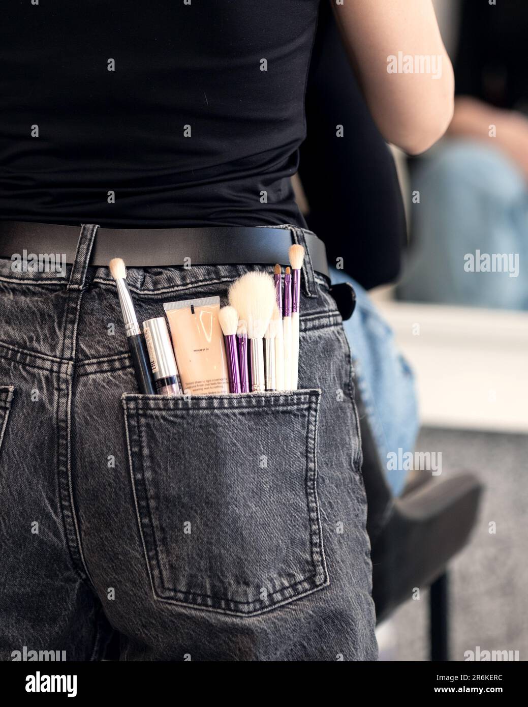 make-up artist makes-up in a beauty salon in front of a mirror Stock Photo