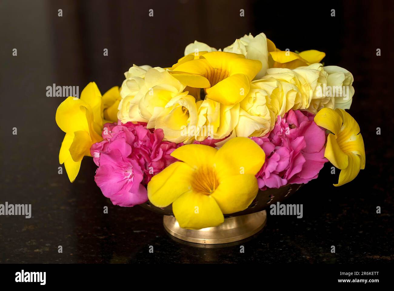 A brass utensil full of flowers, Tamil Nadu, South India, India, Asia Stock Photo