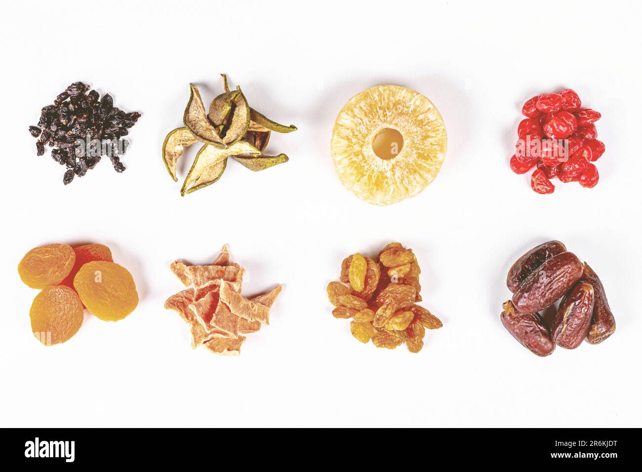 An assortment of dried fruits consisting of oranges and raisins laid out against a white background Stock Photo