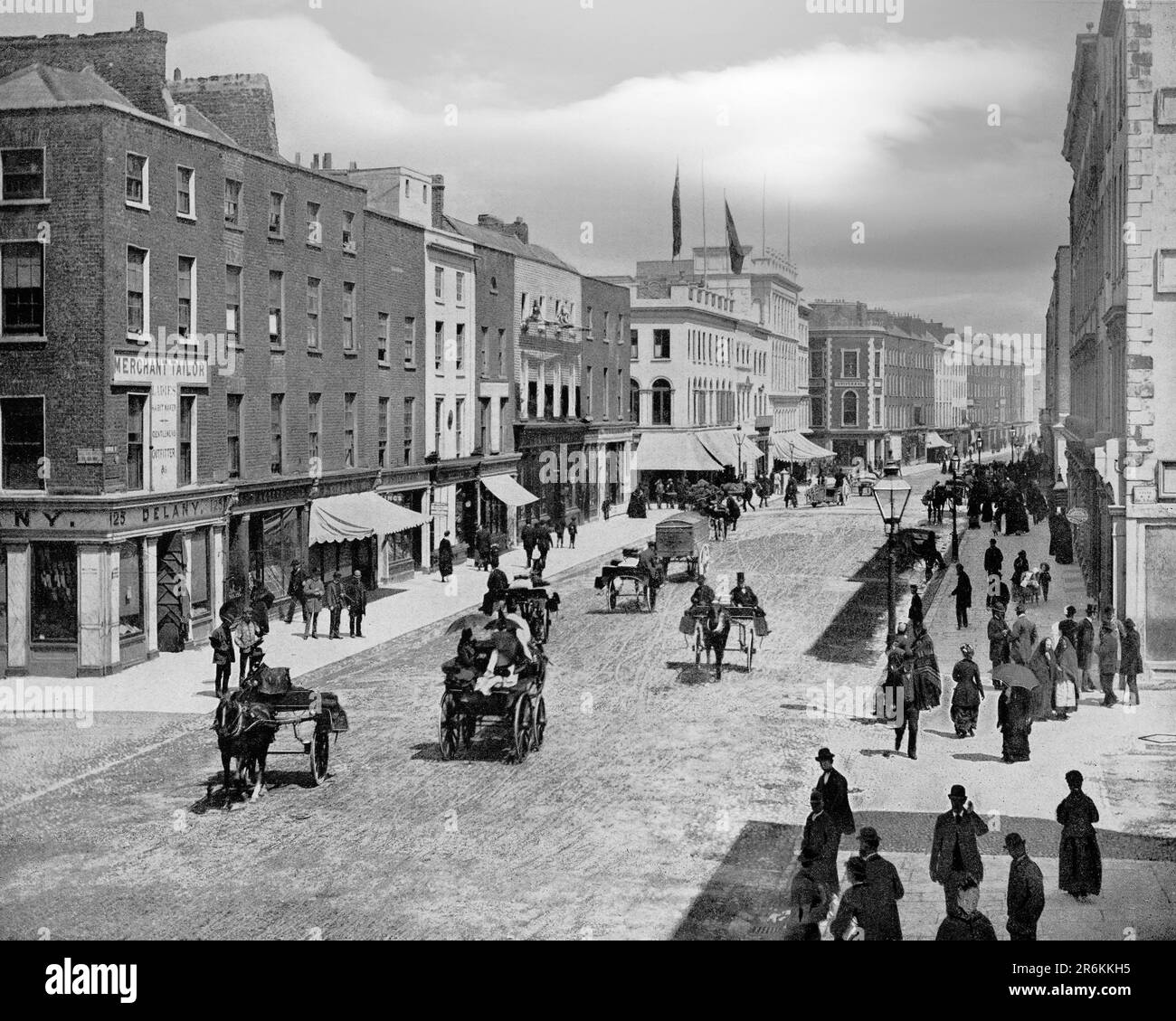 A late 19th century view of George's Street, the main thoroughfare of the city of Limerick, later renamed O'Connell Street after Daniel O'Connell. It dates from the late 18th to early 19th century as part of Edmund Sexton Pery's plan for the development of a new city on lands he owned to the south of the existing medieval city. In 1765, he commissioned the engineer Davis Ducart to design a town plan on those lands which have since become known as Newtown Pery. The centrepiece of this development was O'Connell Street, now part of Limerick's Georgian Quarter. Stock Photo