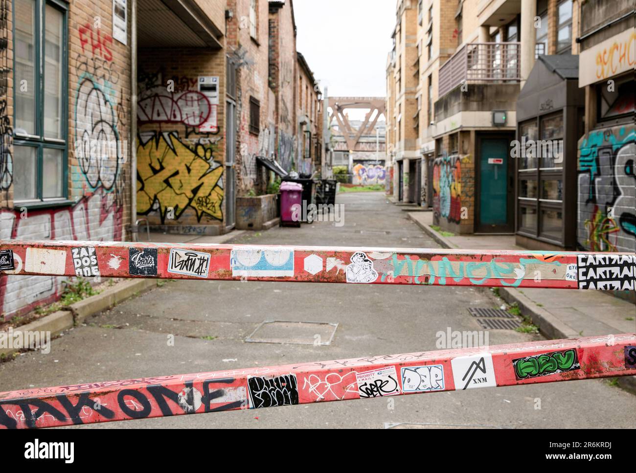London, UK - May 17 2023: Barriers close off a back street in Shoreditch. The gritty inner city area is covered in graffiti. Stock Photo