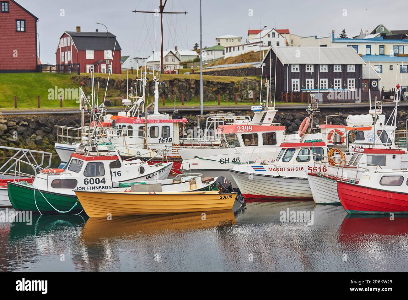 Fishing boats in the harbour at Stykkisholmur, with historic ...