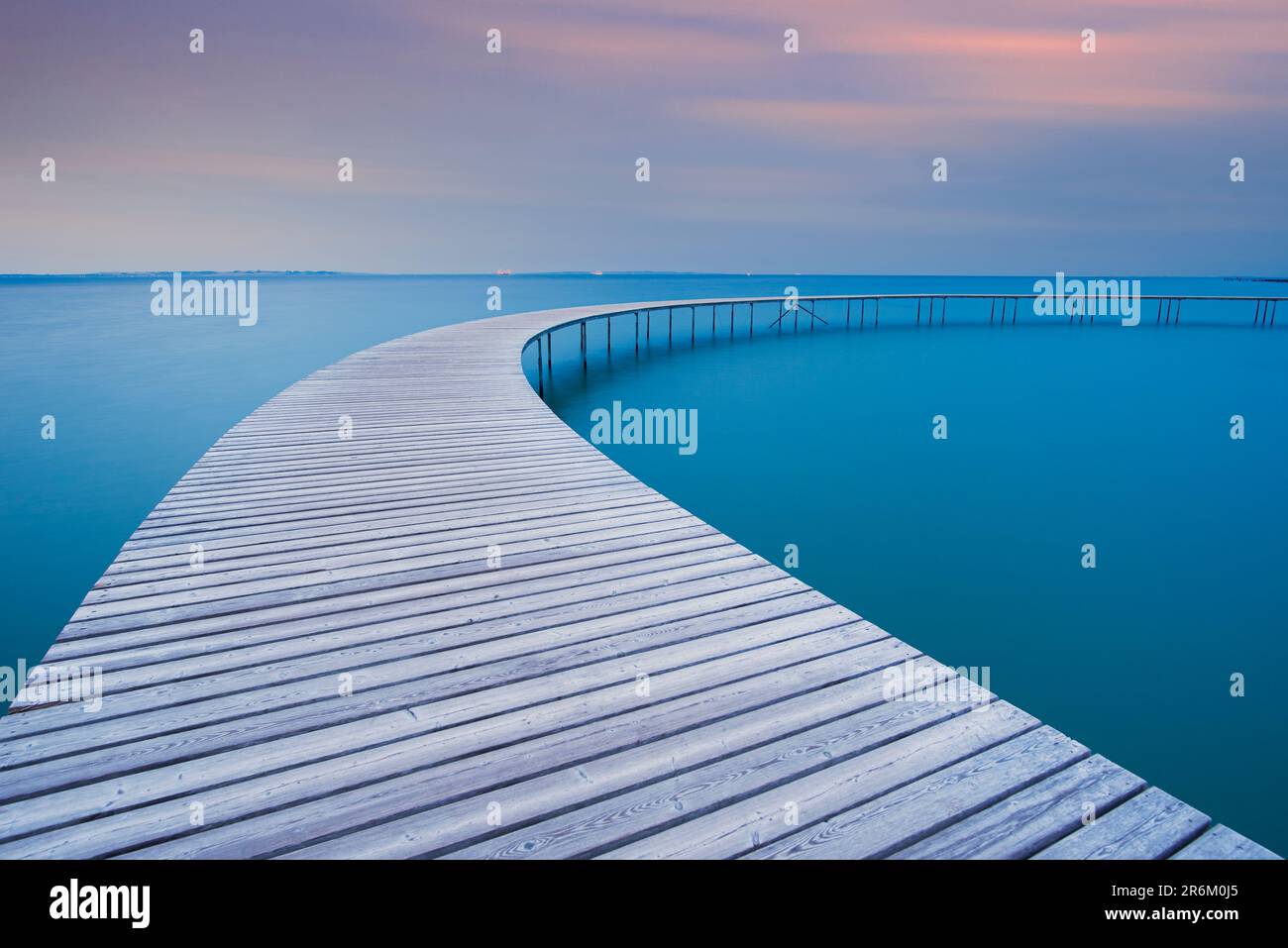 The circle shaped wooden bridge (Infinity Bridge) at dusk, Aarhus, Jutland region, Denmark, Europe Stock Photo