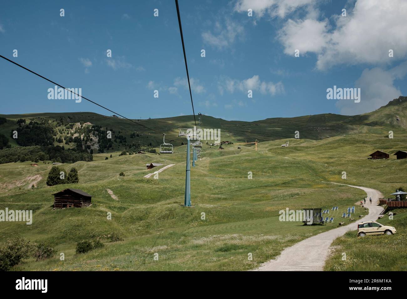 Rope Way View An aerial view of a ropeway above a green landscape of hills on a sunny ...