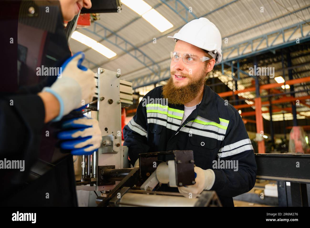 Engineer Reparing Machine Mechanical engineers repairing engine machine at factory Stock Photo ...