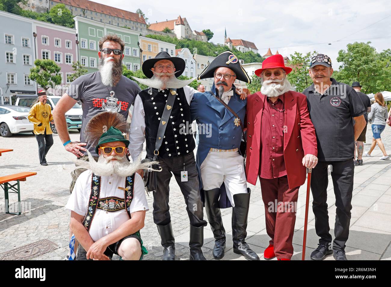 Burghausen, Germany. 10th June, 2023. Participants pose for a photo against the historic backdrop of Burghausen, Germany, on the second day of the World Beard and Mustache Championships. Credit: Uwe Lein/dpa/Alamy Live News Stock Photo