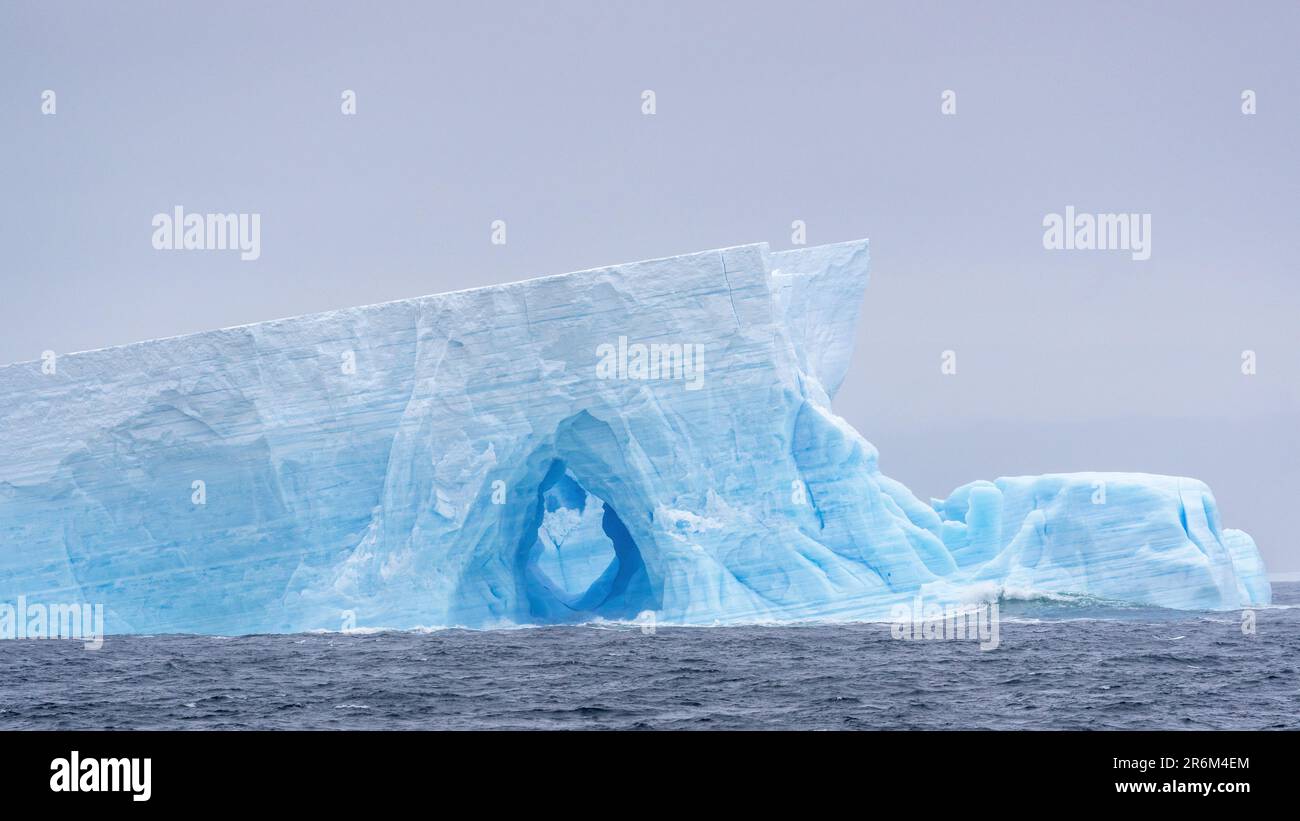Iceberg with Arch, Bellingshausen Sea, Antarctica Stock Photo