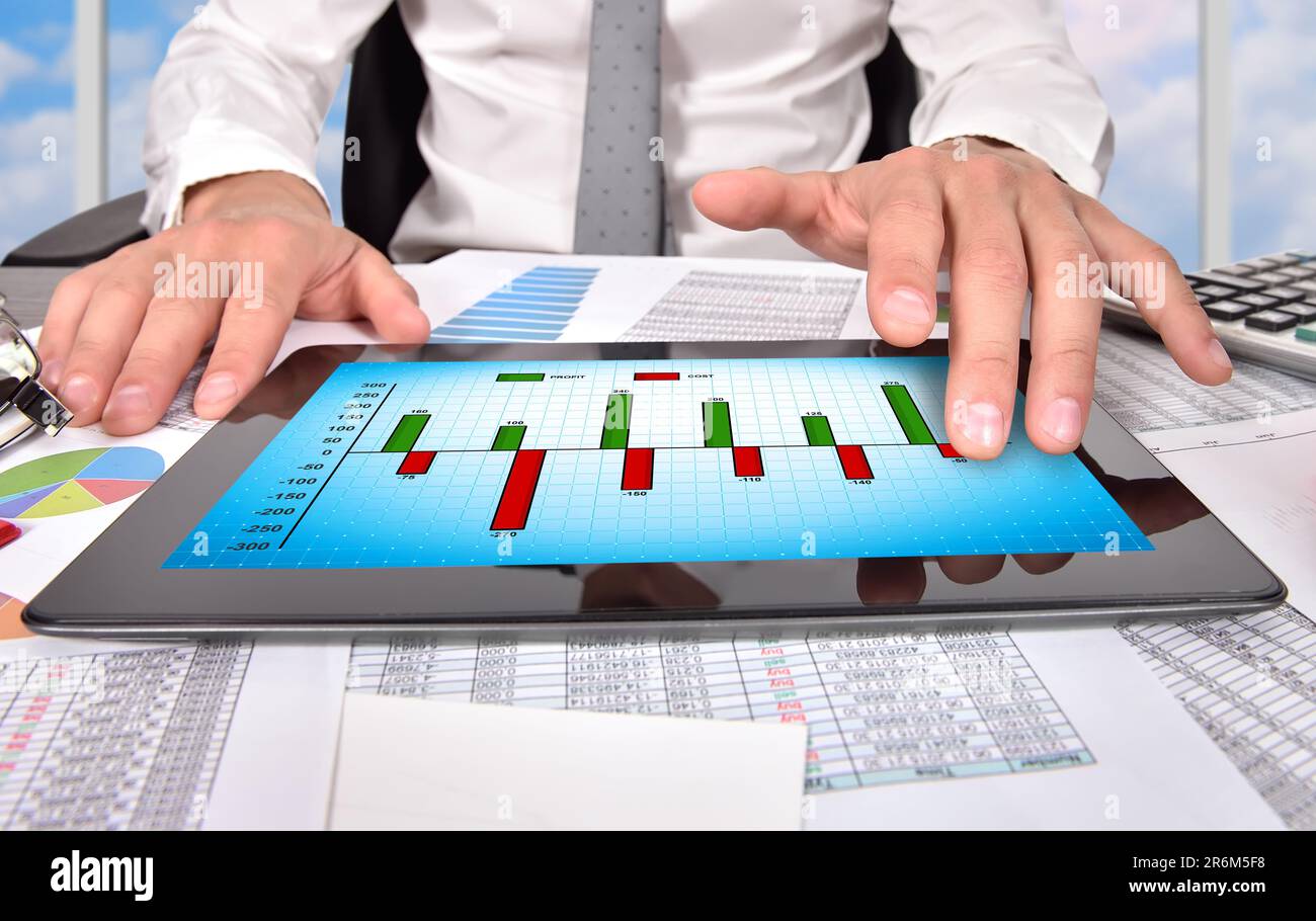 businessman hand touching digital tablet with chart of profit and cost