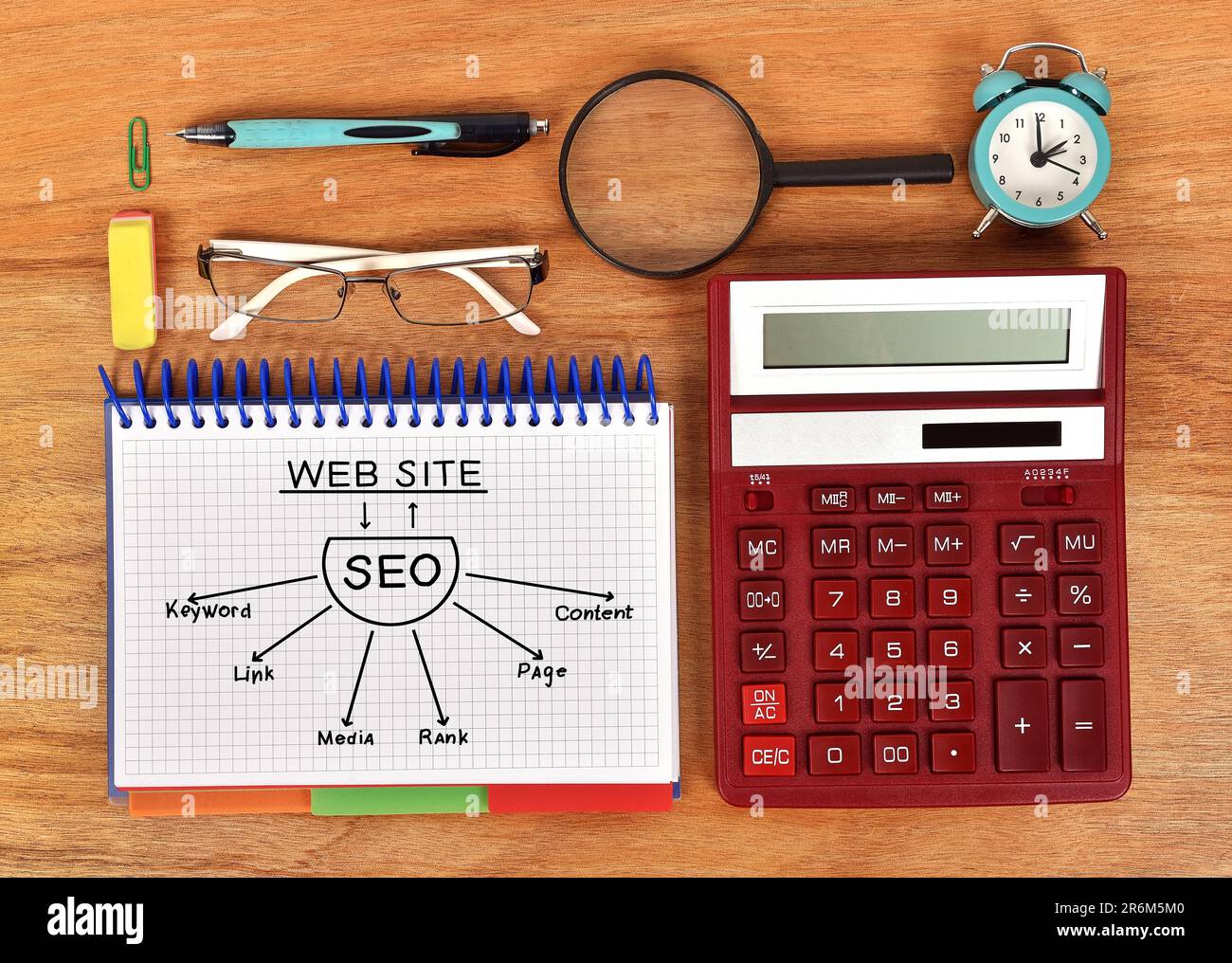 drawing seo scheme in notebook and red calculator Stock Photo