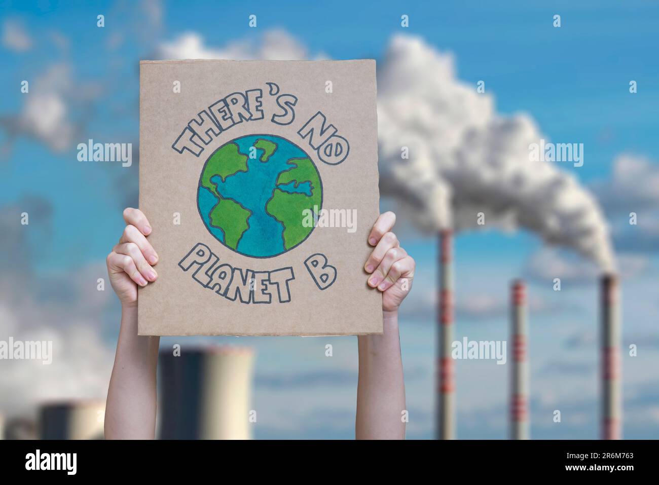 Climate change manifestation poster on an industrial fossil fuel burning Stock Photo