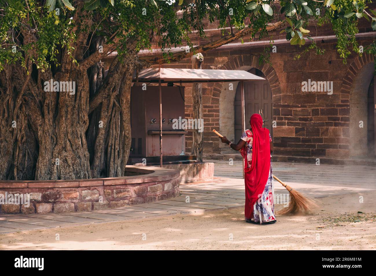 Woman sweeping cleaning the ground in Mehrangarh fort. Jodhpur, Rajasthan, India Stock Photo