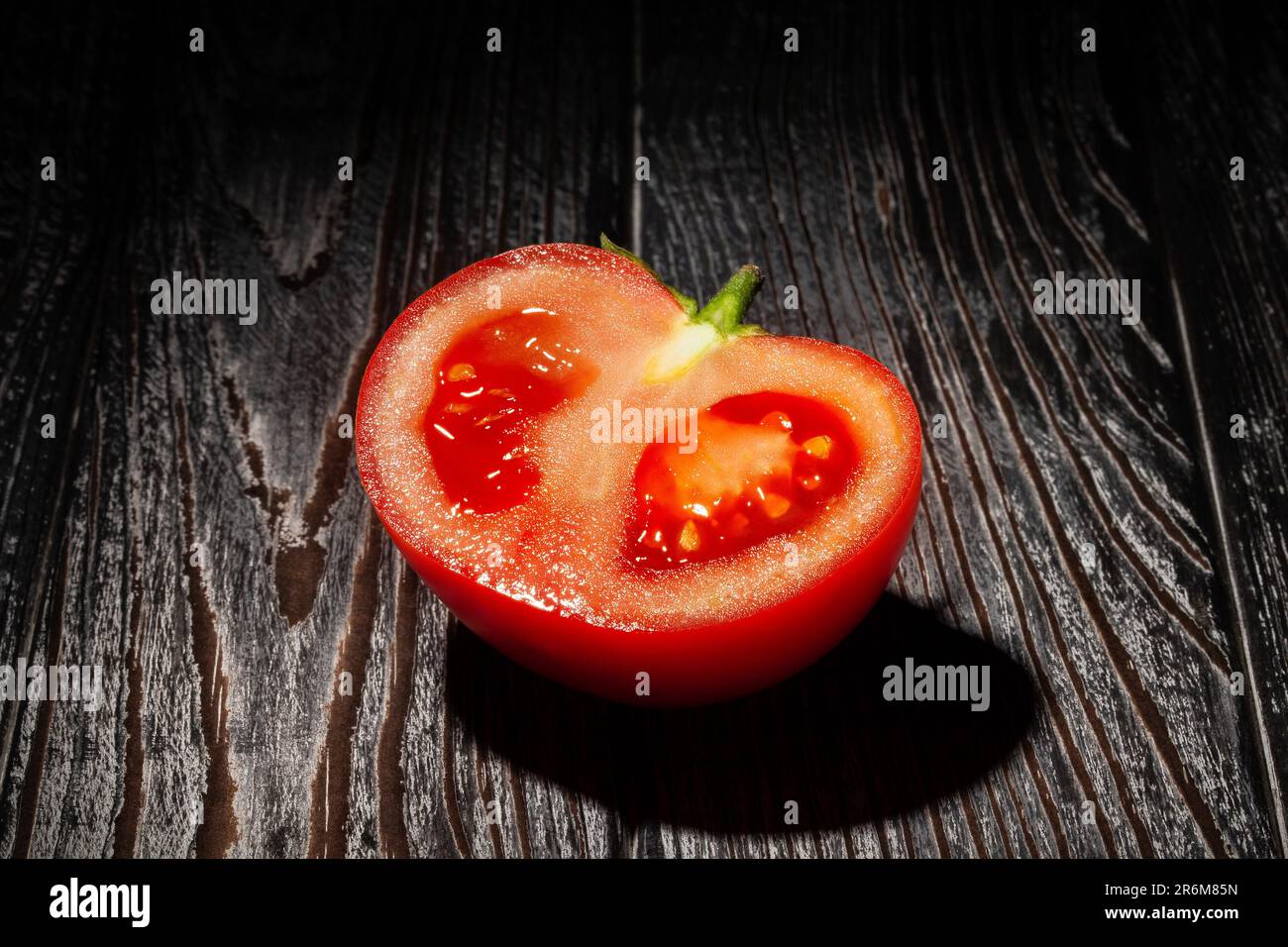 sliced red tomato on wood background Stock Photo