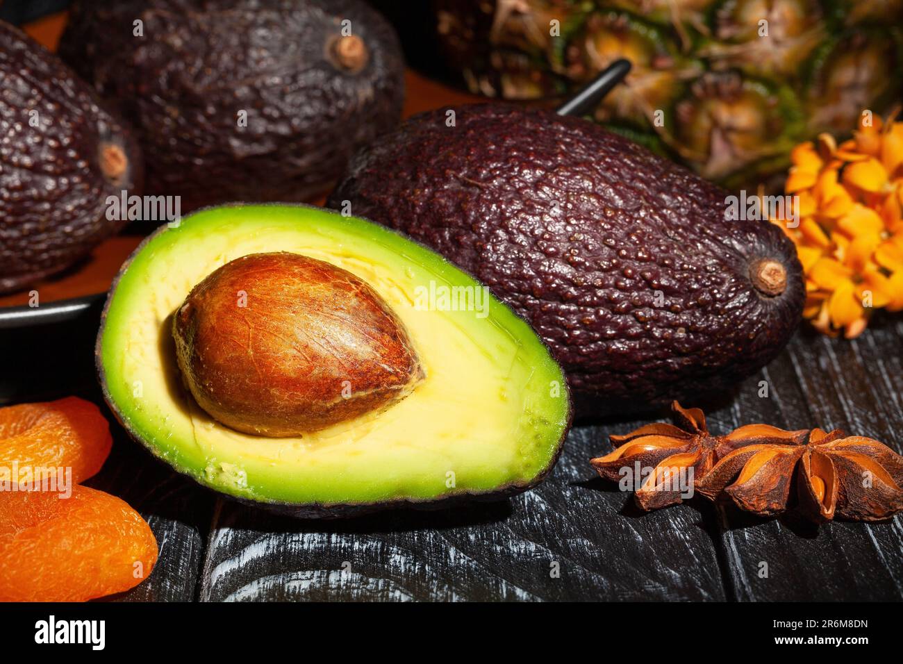 sliced hass avocado on wood background Stock Photo