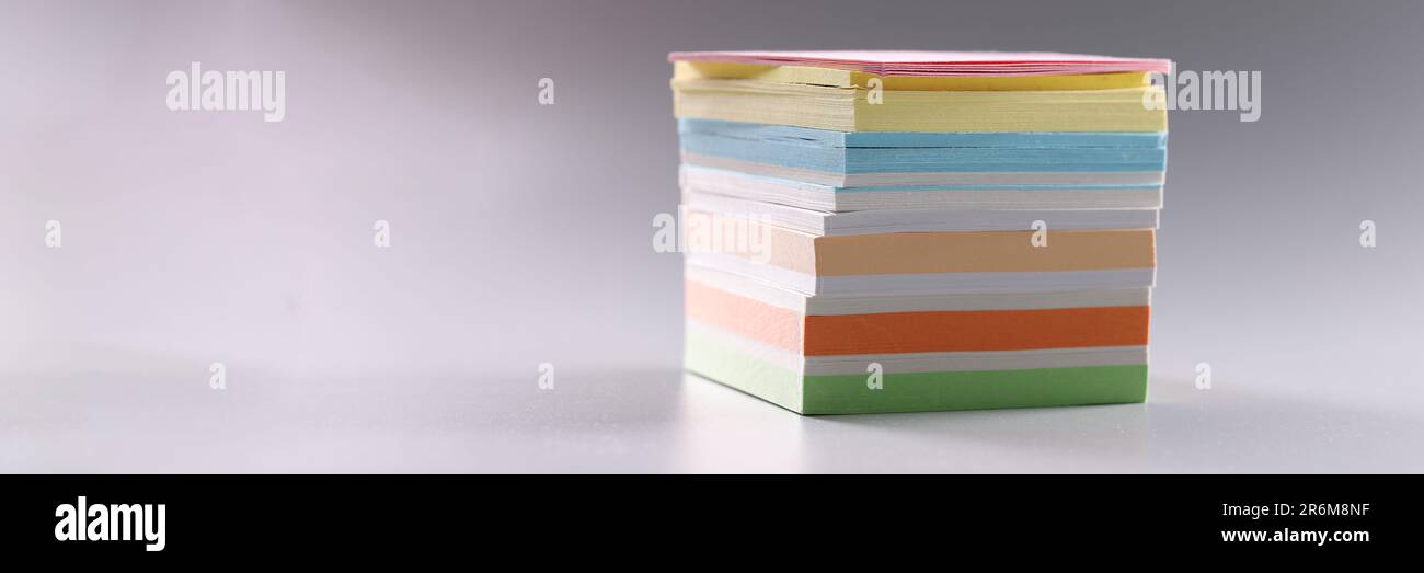 Stack of multicolored sticky notes on gray background Stock Photo
