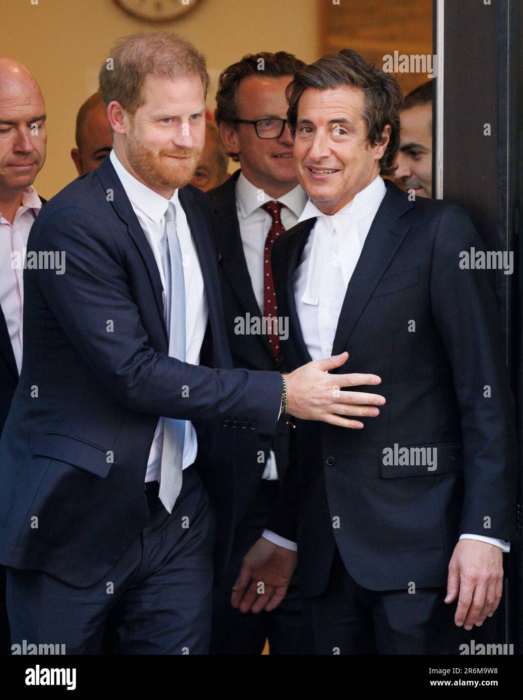 Prince Harry (L) gestures to lawyer David Sherborne (R) as he leaves the High Court today following the third day of trial against Mirror Group Newspa Stock Photo