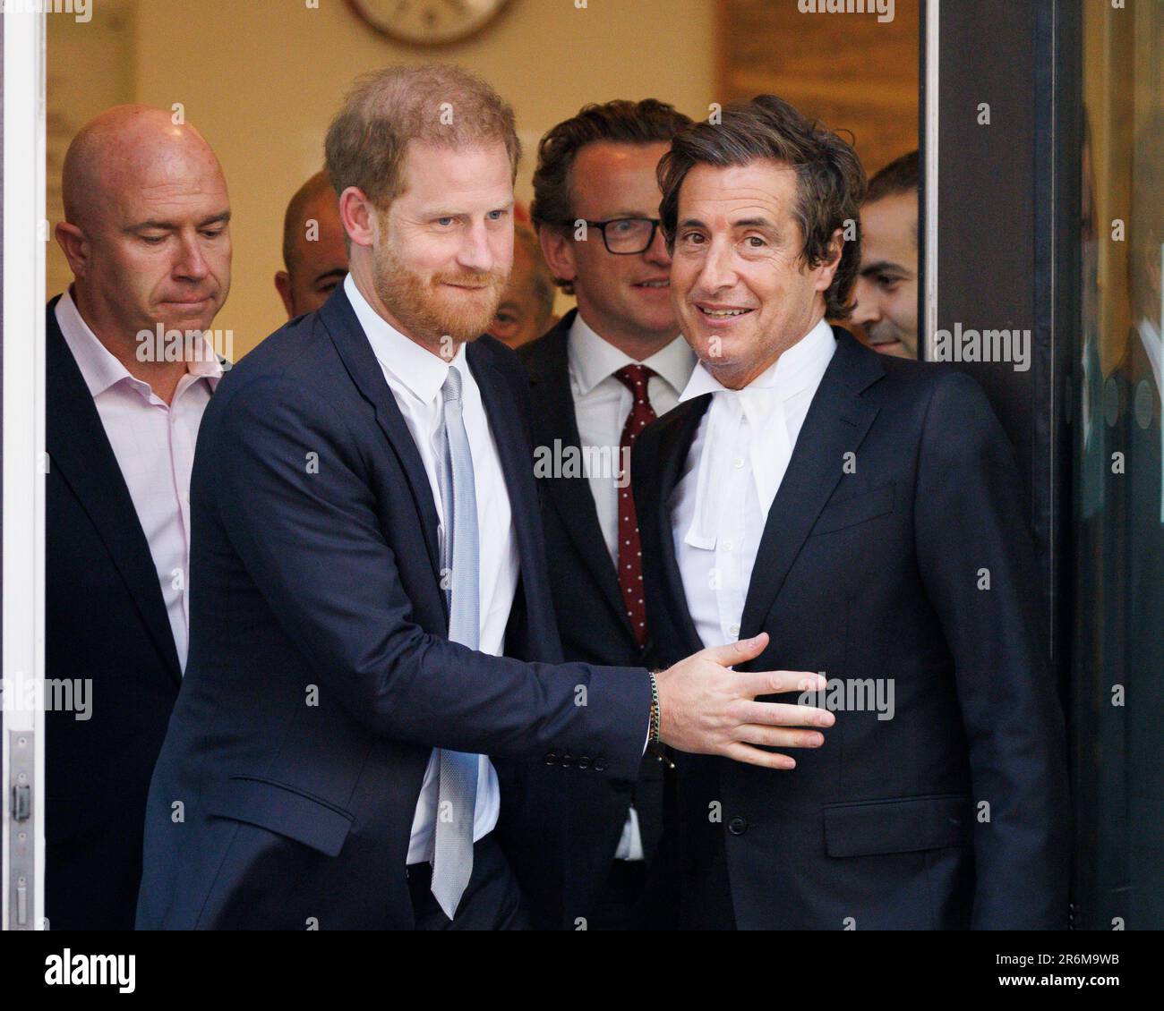 Prince Harry (L) gestures to lawyer David Sherborne (R) as he leaves the High Court today following the third day of trial against Mirror Group Newspa Stock Photo