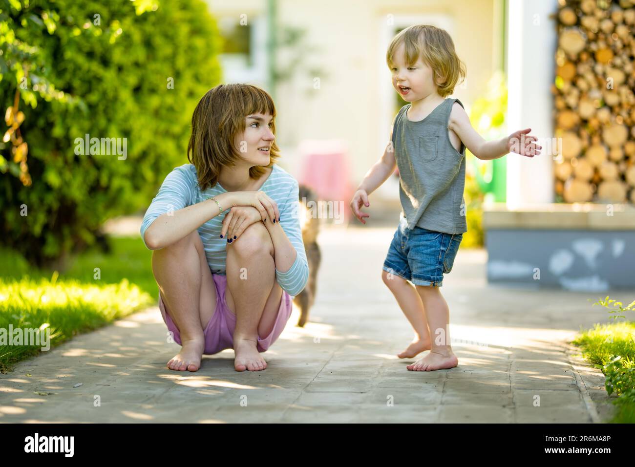 Cute big sister cuddling with her toddler brother. Adorable teenage