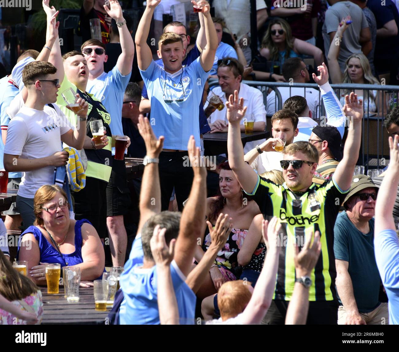 Manchester, UK, 10th June, 2023. Fans of Manchester City Football Club singing, happy and confident outside the Old Wellington pub during the afternoon in central Manchester, UK, before the UEFA Champions League 2022-23 final between Man City and Inter Milan at the Ataturk Olympic Stadium in Istanbul, Turkey.  Credit: Terry Waller/Alamy Live News Stock Photo