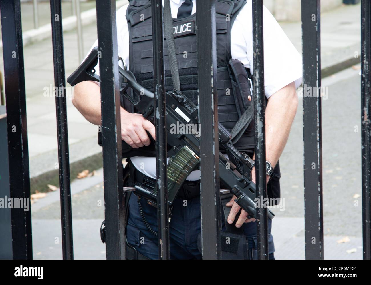 A law enforcement officer standing in a defensive position, equipped