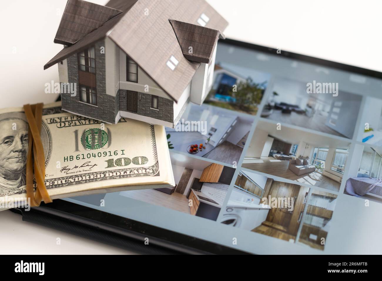 Small house model is on screen tablet and icons home electronics ...