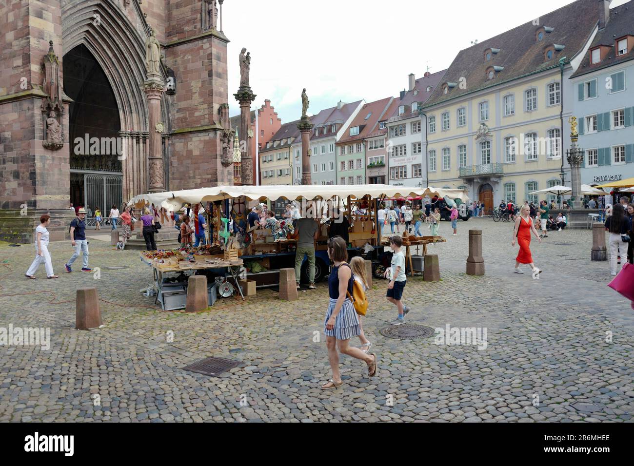 Market activity in front of the Freiburg Muenster in Germany Stock Photo