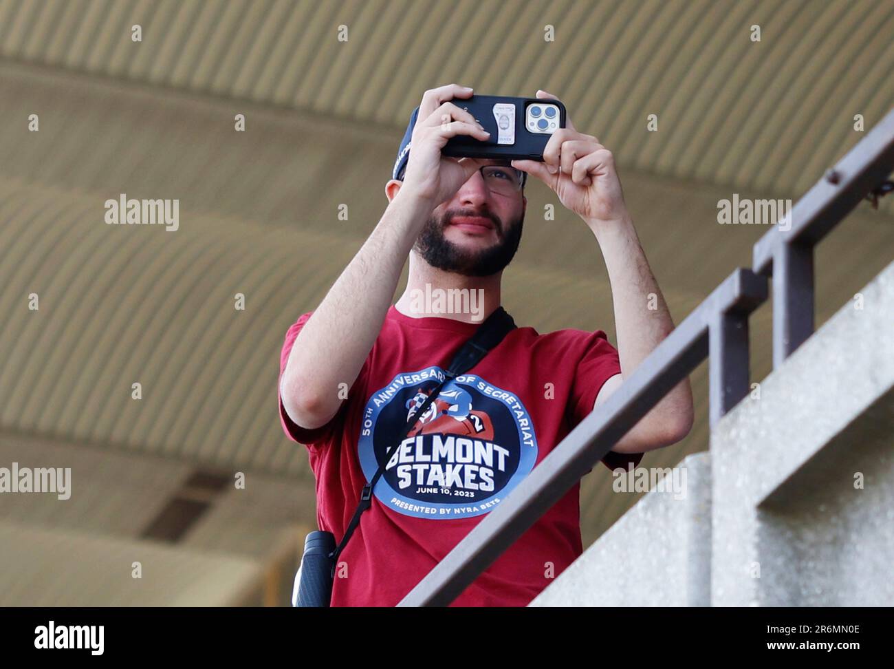 Elmont, United States. 10th June, 2023. A racing fan watches the 3rd