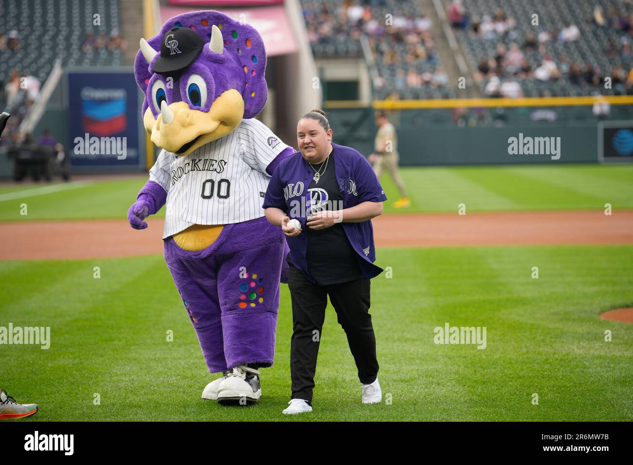 Colorado Rockies mascot Dinger the dinosaur congratulates Tara Bush, a  bartender at Club Q during a massacre in the gay club in November 2022 in  Colorado Springs, Colo., after she tossed the