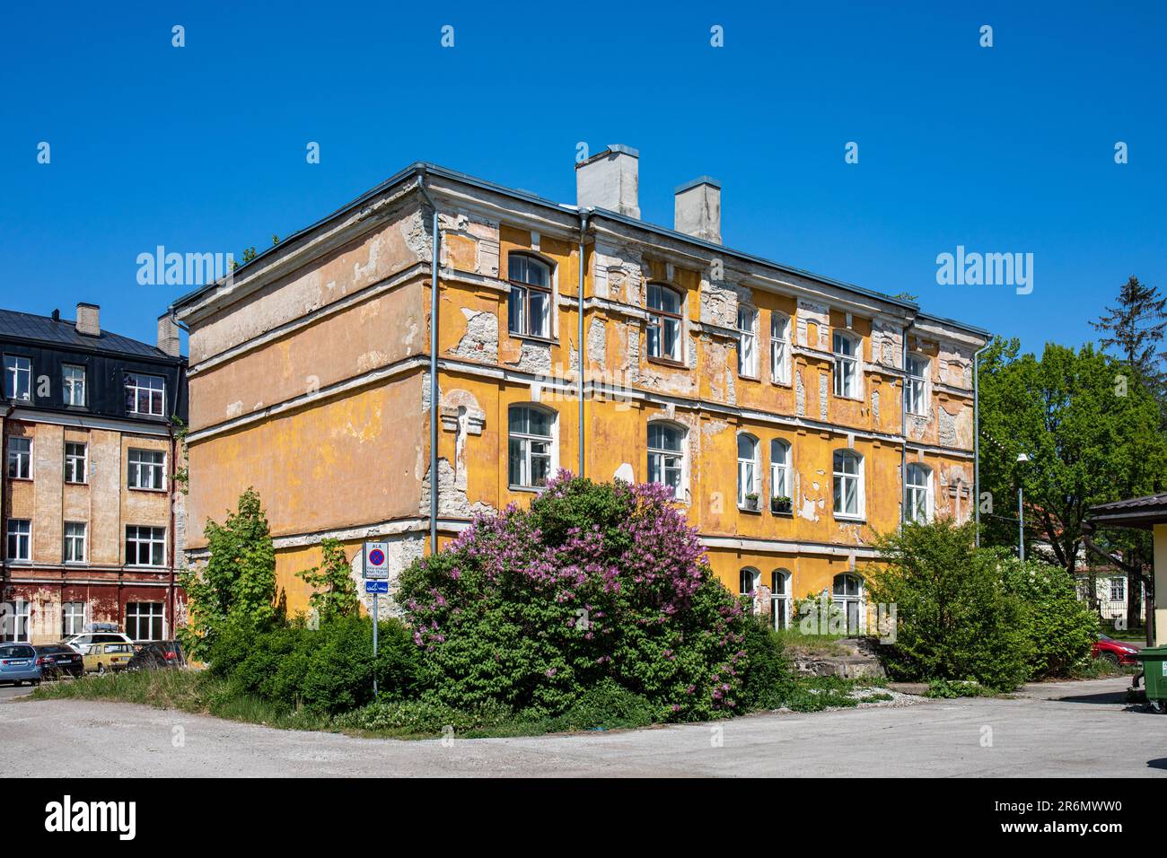 Derelict looking residential building against clear blue sky on a sunny day at Kopli 75 in Kopli district of Tallinn, Estonia Stock Photo