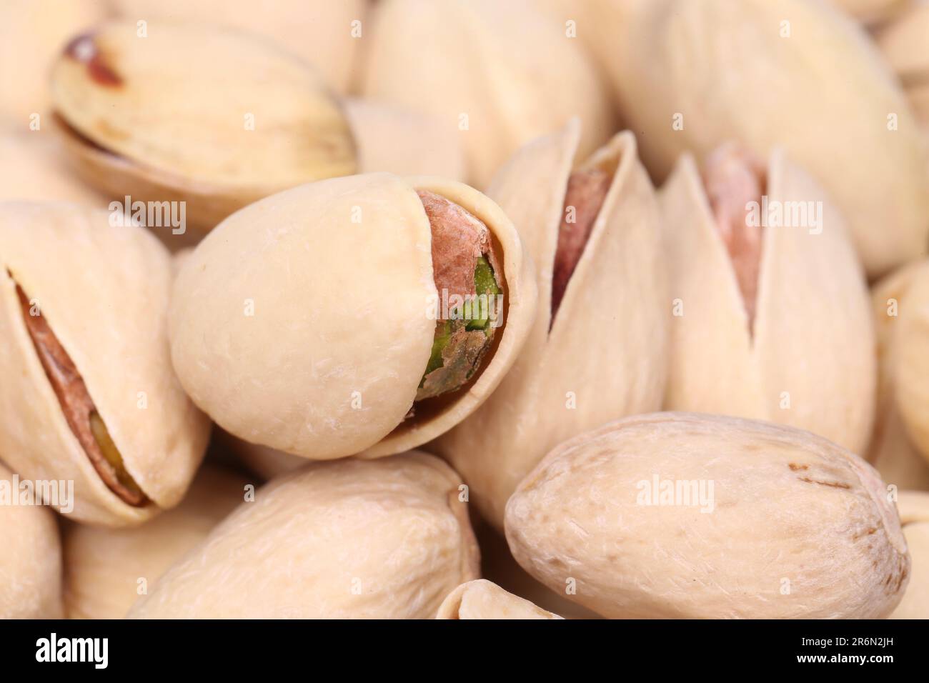 Wallpaper of pistachios with one open pistachio Stock Photo Alamy