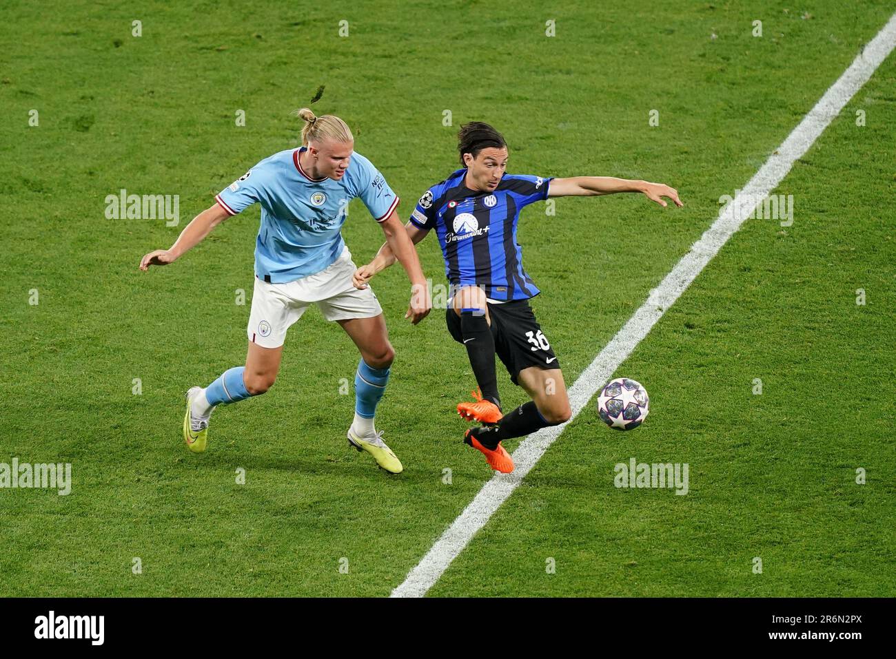 Inter Milan's Alessandro Bastoni, left, heads the ball past Manchester  City's Erling Haaland during the Champions League final soccer match  between Manchester City and Inter Milan at the Ataturk Olympic Stadium in