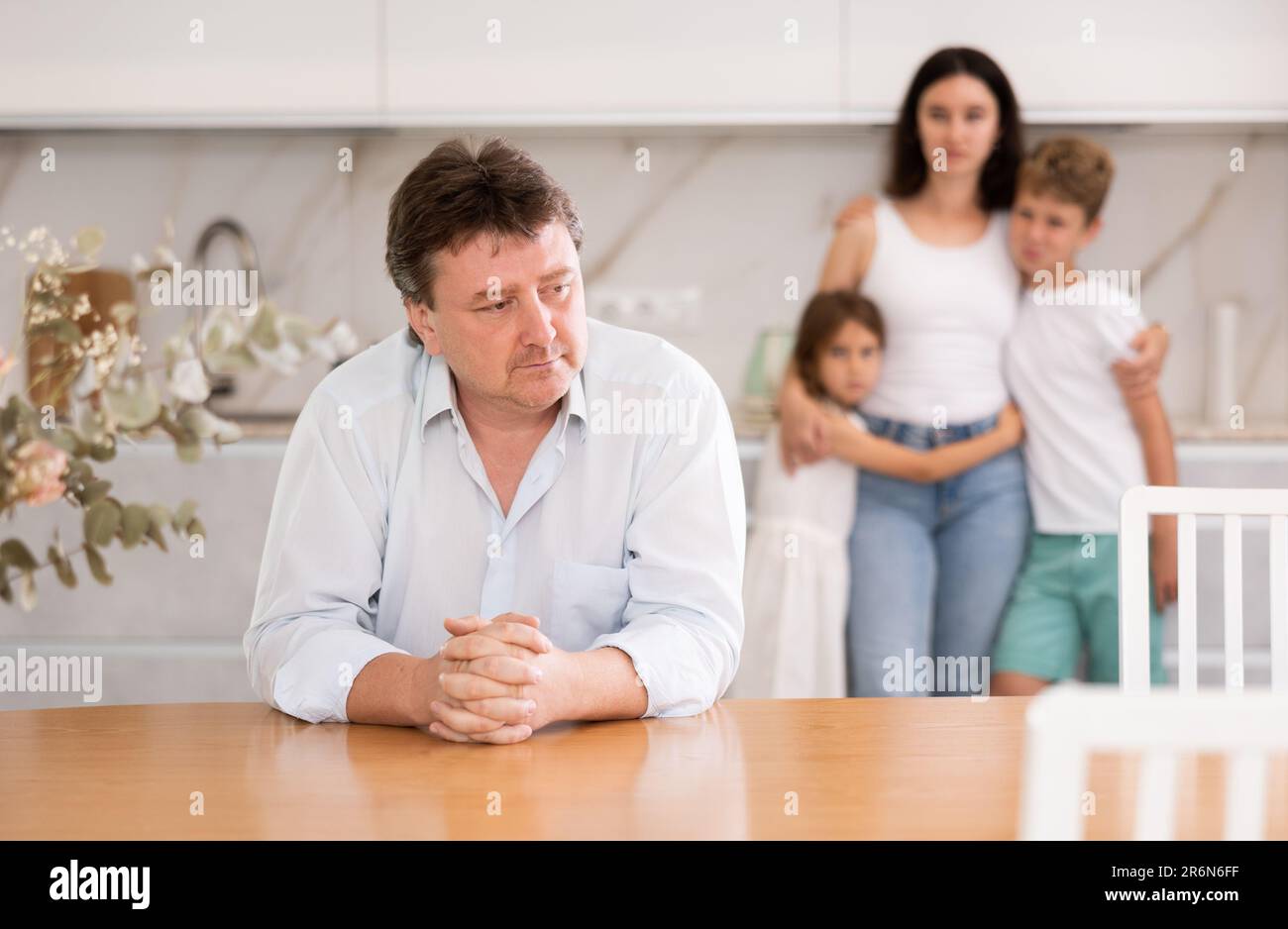 Wife and children stand behind dad and are afraid to ask about current ...