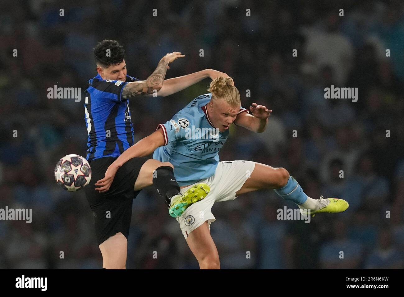 Inter Milan's Alessandro Bastoni, left, heads the ball past Manchester  City's Erling Haaland during the Champions League final soccer match  between Manchester City and Inter Milan at the Ataturk Olympic Stadium in