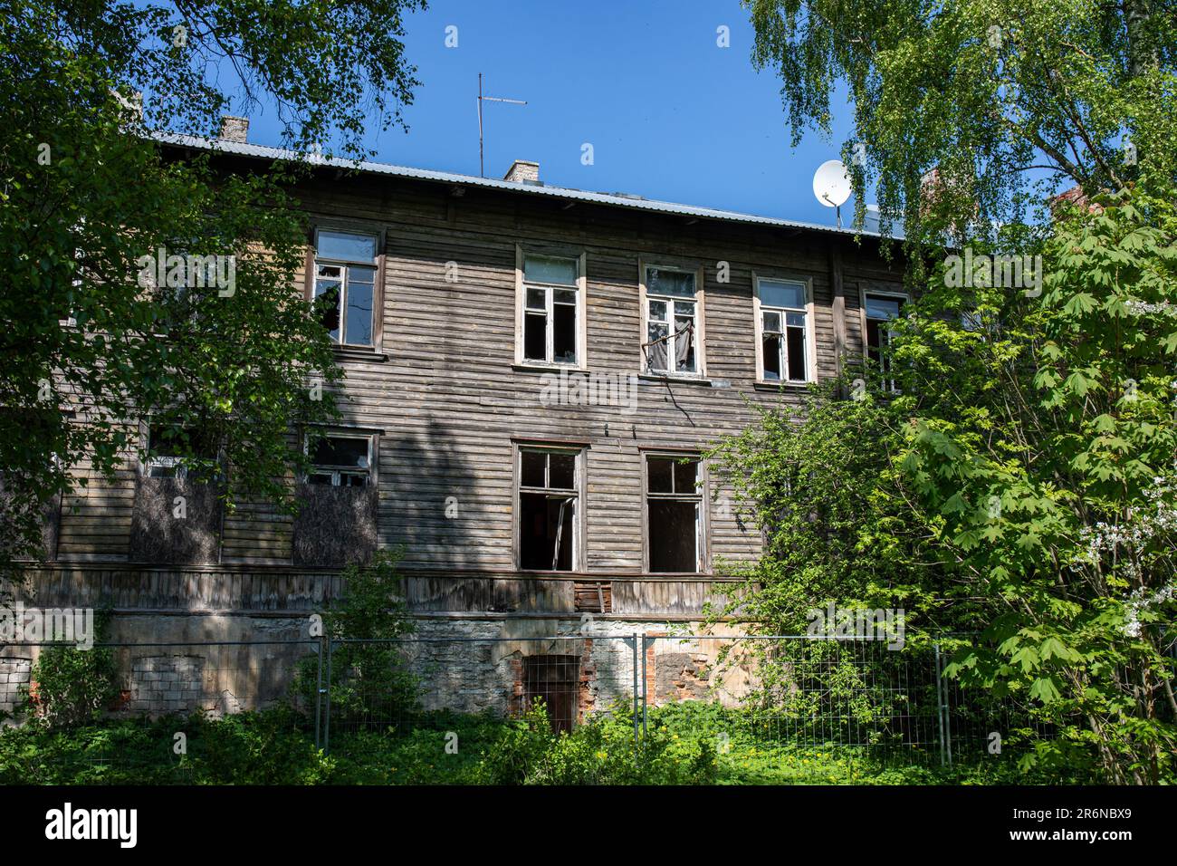 Kopli Lines or Kopli liinid. Abandoned and derelict wooden residential building against clear blue sky in Kopli district of Tallinn, Estonia. Stock Photo