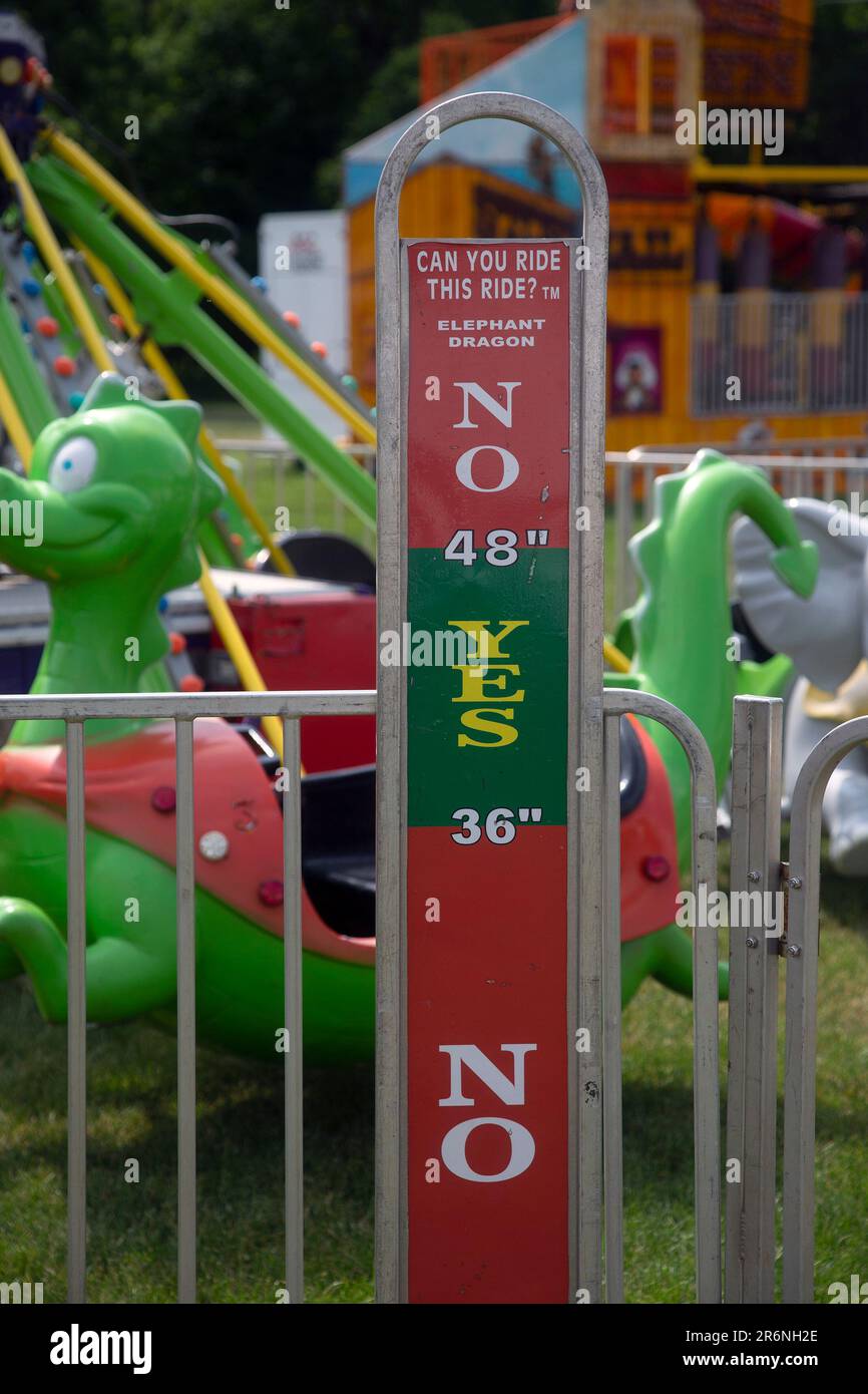 Sign showing minimum height requirement for a carnival ride Stock Photo