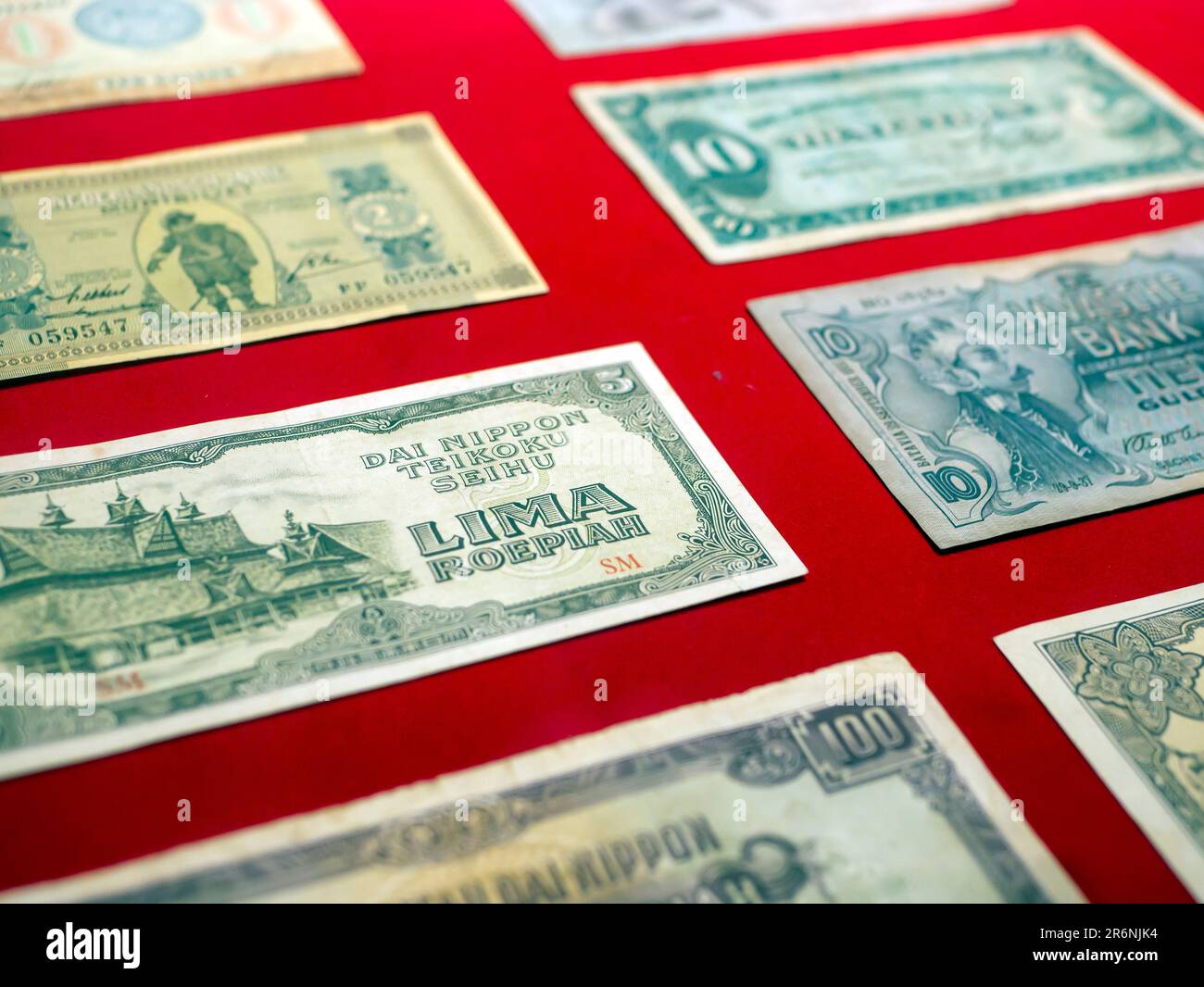 Close up view of old Indonesian banknotes. Old rupiah currency, money concept. Selected focus. Stock Photo