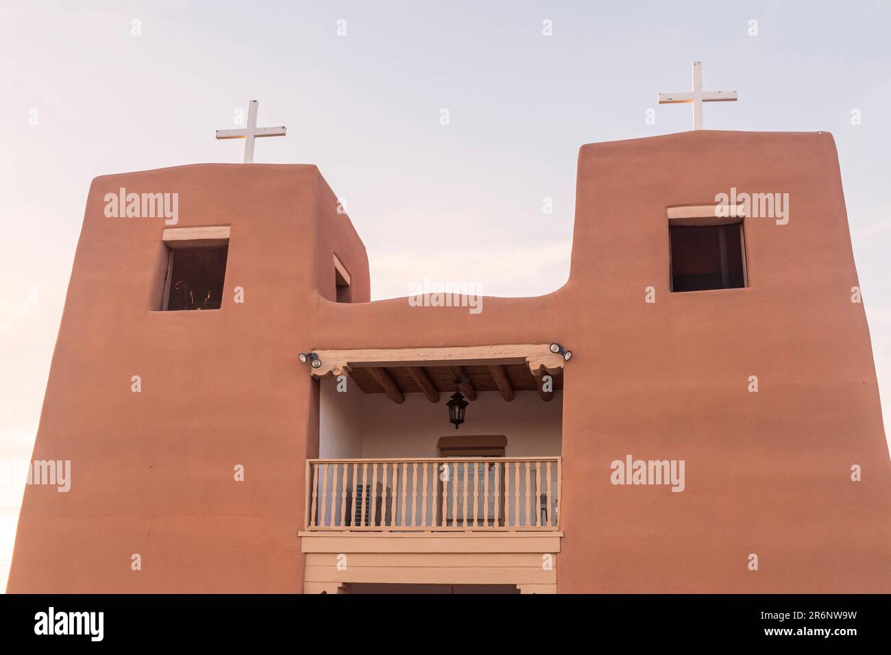 Horizontal image of the two towers of the Sagrado Corazón de Jesus church in Nambe, New Mexico, each with a cross on the top. Stock Photo