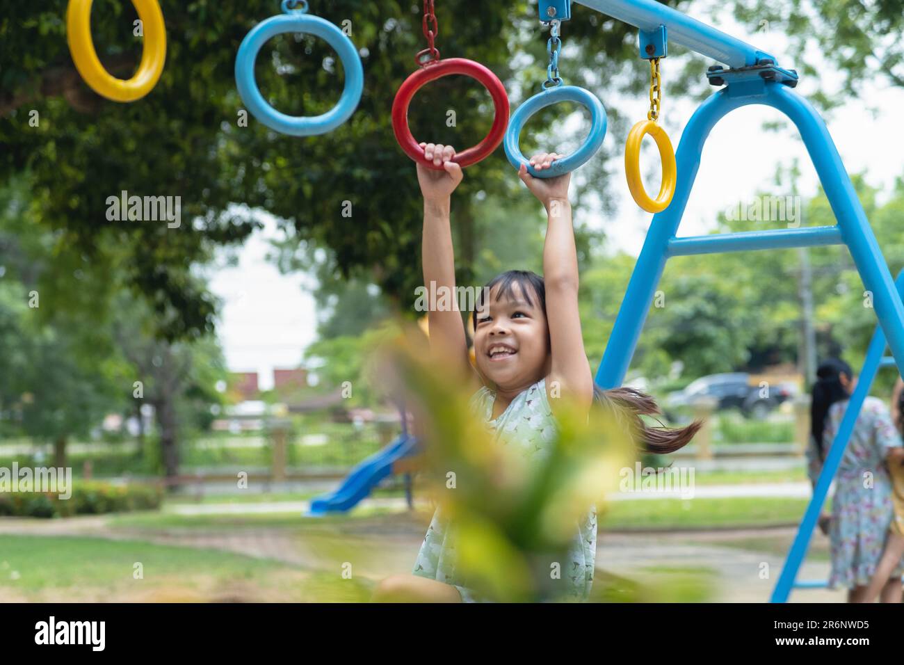 Happy Girl Hanging On Monkey Bar By Hand Doing Exercise Little Asian happy-girl-hanging-on-monkey-bar-by-hand-doing-exercise-little-asian