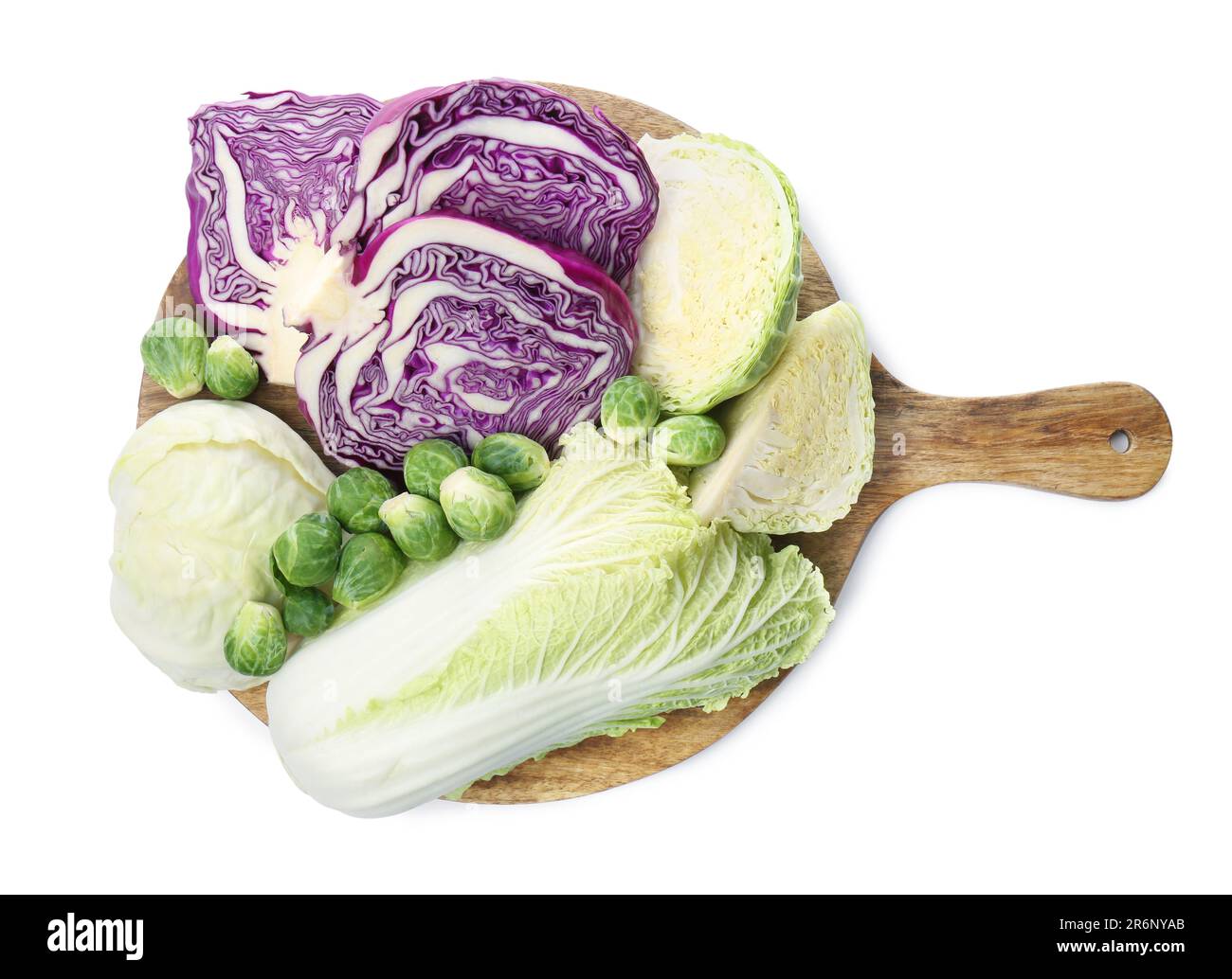 Wooden board with different types of cabbage isolated on white, top ...